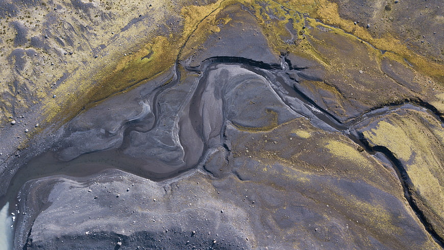 Aerial view of tidal creeks and mossy rocks in Iceland