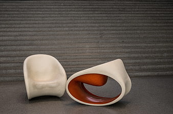 Modern White Sculptural Chair and Ottoman on Gray Background
