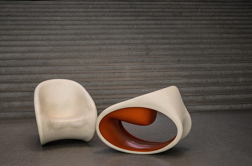 Modern White Sculptural Chair and Ottoman on Gray Background
