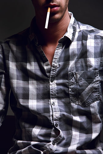 Man smoking cigarette in plaid shirt close-up
