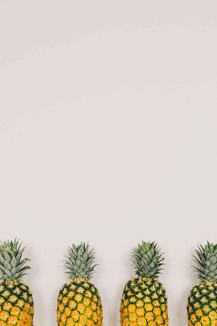 Minimalist Row of Pineapples on White Background