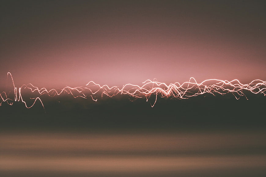 Abstract Electric Light Trails Against Muted Sunset Sky