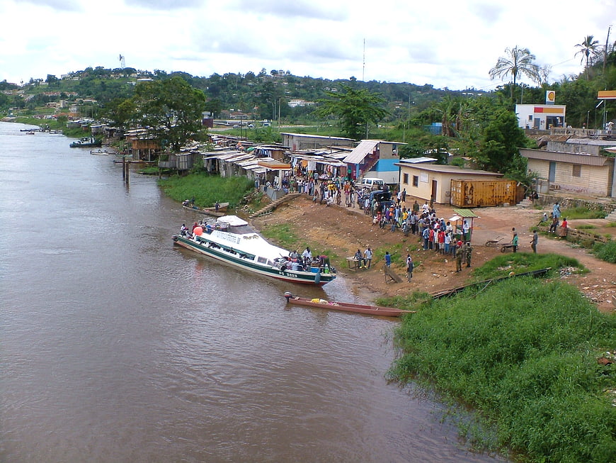 River ferry docked at bustling riverside village in Lambaréné