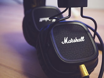 Close-up of black Marshall headphones on wooden surface