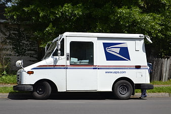White USPS Mail Delivery Truck Parked On Suburban Street