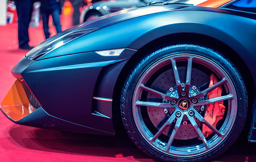 Close-up of Matte Blue Lamborghini Front Wheel and Bumper