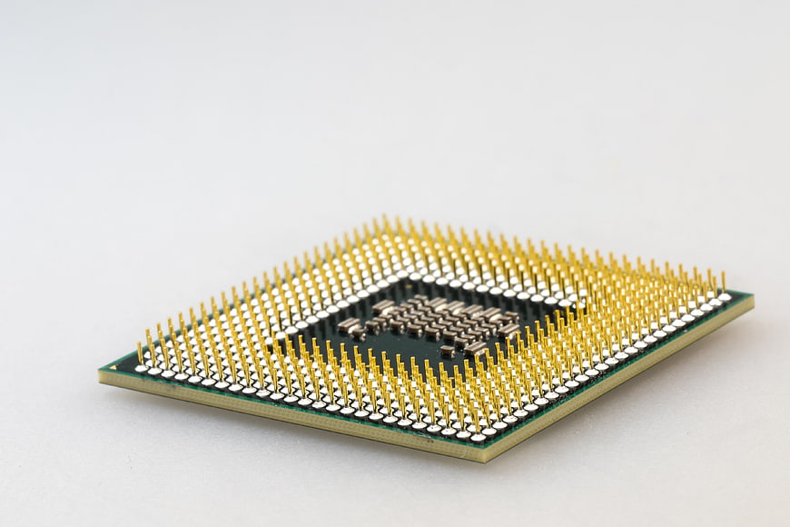 Close-up of a computer processor chip with gold pins