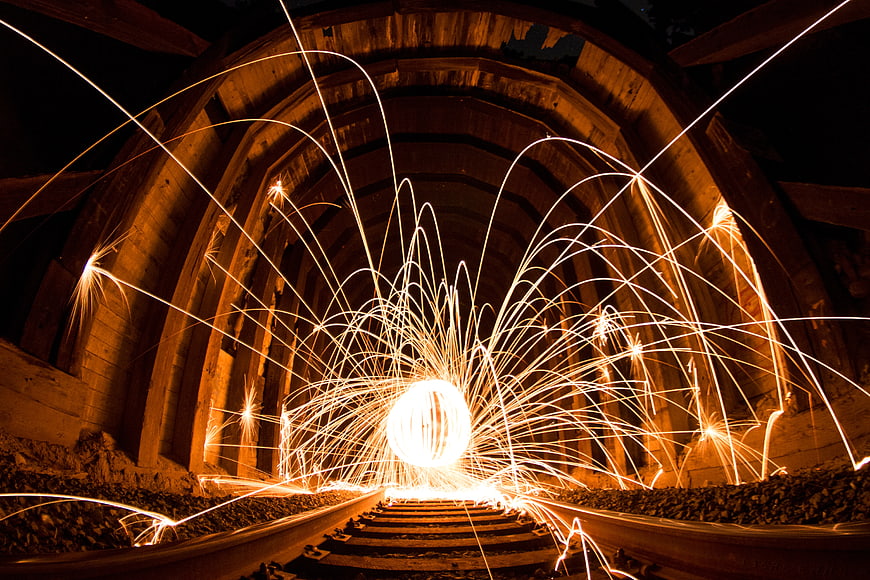 Steel wool sparks in abandoned railway tunnel at night