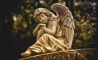 Sepia Toned Stone Angel Statue Sitting In A Graveyard