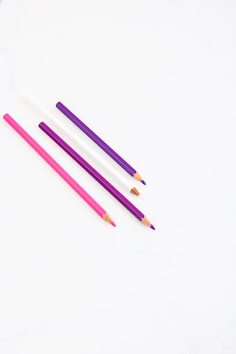 Minimalist colored pencils on white background