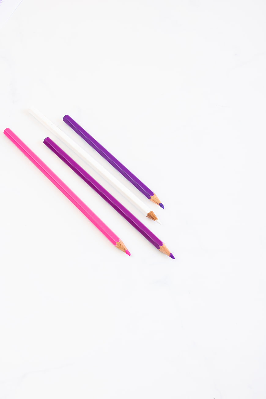 Minimalist colored pencils on white background