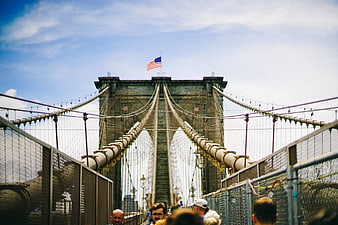 Brooklyn Bridge Tower with American Flag and Pedestrians