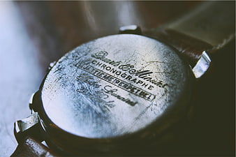 Close-up of vintage watch back with engraved text