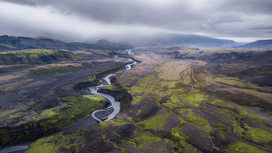 Aerial View of Mossy Lava Fields and River in Iceland