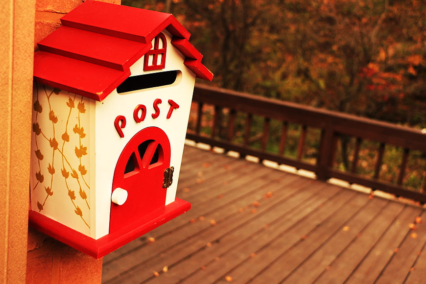 Red Cottage Mailbox On Wooden Deck
