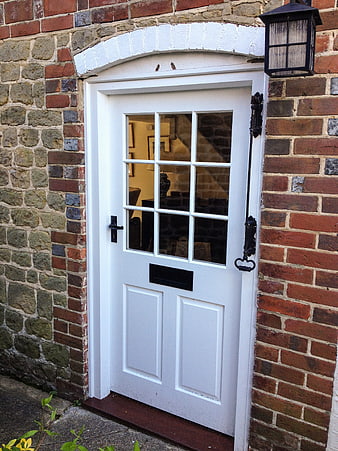 White Front Door with Glass Panes on Brick House Exterior