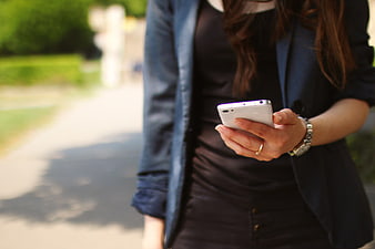 Woman in Business Attire Using White Smartphone Outdoors