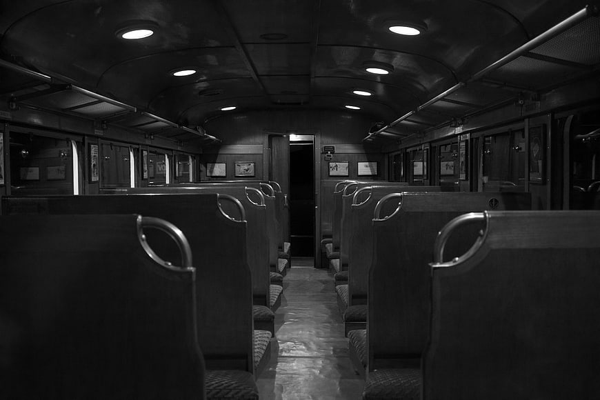 Empty vintage train carriage interior in black and white