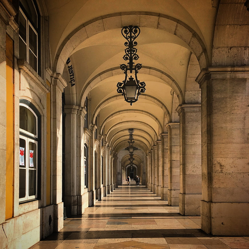 Perspective view of stone arcade with hanging lanterns