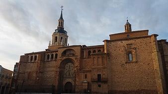 Historic stone church with clock tower and arched facade