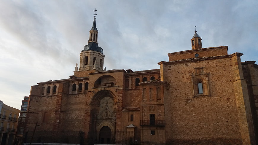 Historic stone church with clock tower and arched facade