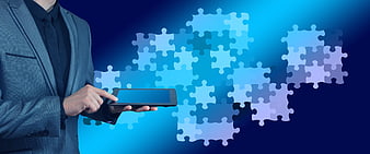 Businessman Using Tablet With Digital Puzzle Pieces Background