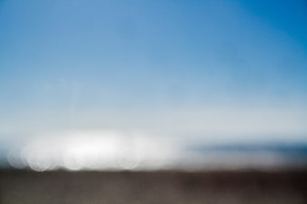 Abstract Blurred Beach Background with Blue Sky and Bokeh