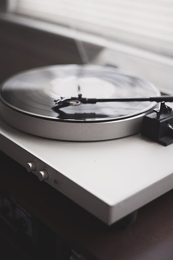 White Turntable Playing Vinyl Record with Motion Blur