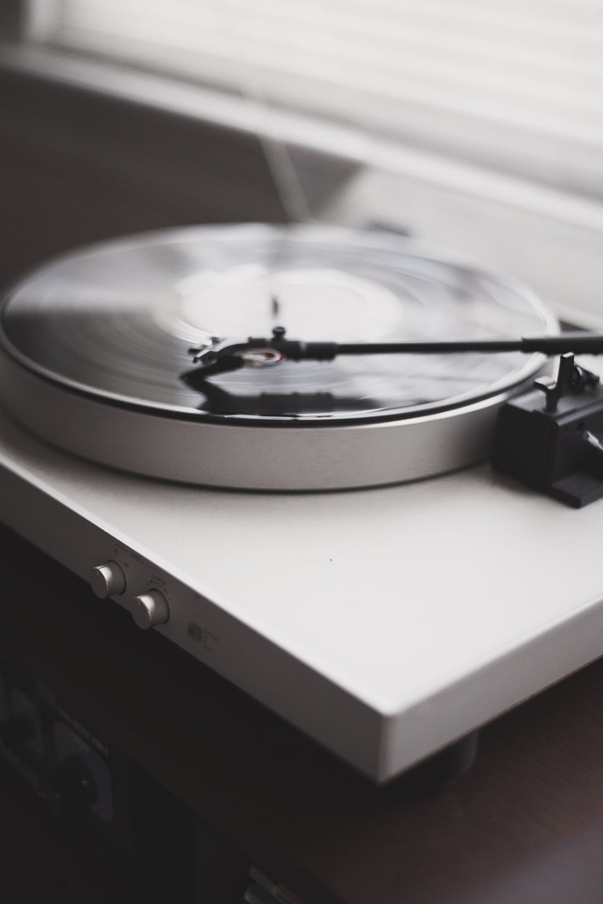 White Turntable Playing Vinyl Record with Motion Blur