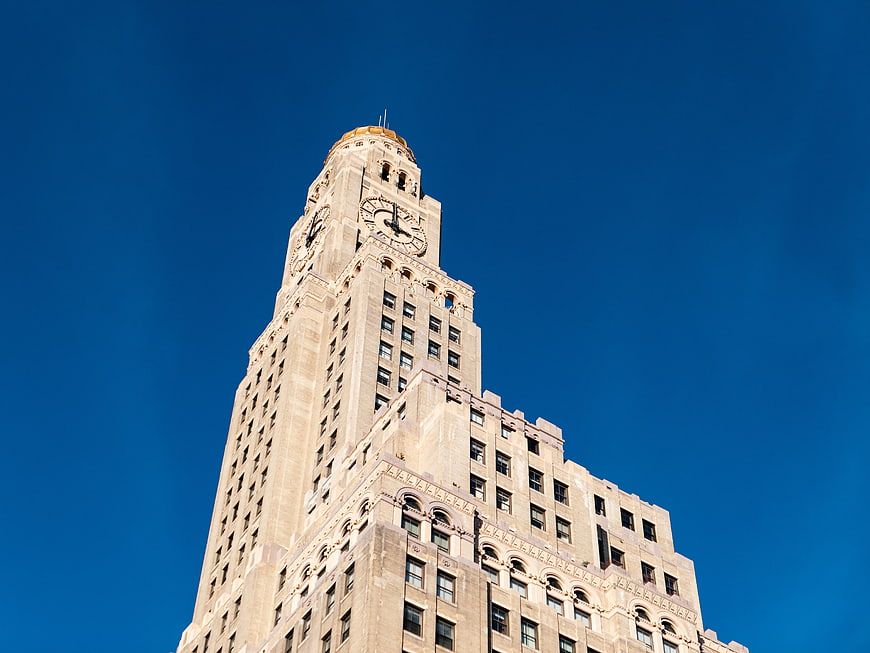 Low angle view of historic clock tower against blue sky