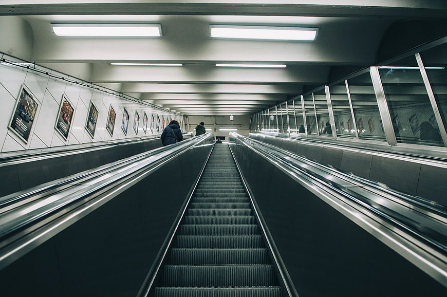 Symmetrical view of long escalator in modern subway station