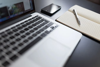 Modern Workspace with Laptop, Notebook, and Smartphone