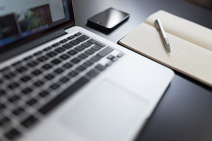 Modern Workspace with Laptop, Notebook, and Smartphone