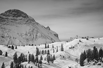 Black and white winter mountain landscape with ski lifts