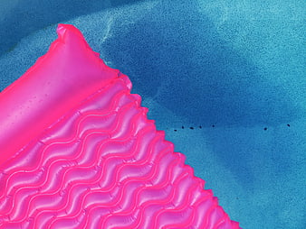 Pink Inflatable Pool Float on Blue Water