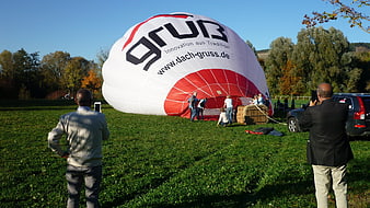 Hot air balloon inflation with spectators taking photos