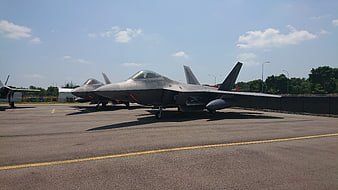 F-35 Lightning II fighter jets parked on airfield tarmac