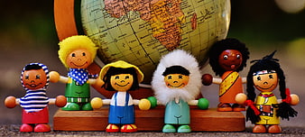 Diverse Wooden Dolls Holding Hands in Front of Globe