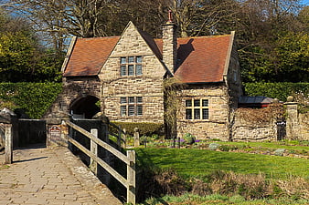 Historic Stone Cottage with Arched Bridge in English Countryside