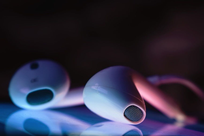 White Earbuds with Neon Blue and Pink Lighting