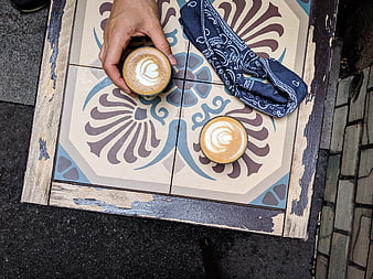 Top View of Cappuccino Coffee on Patterned Table