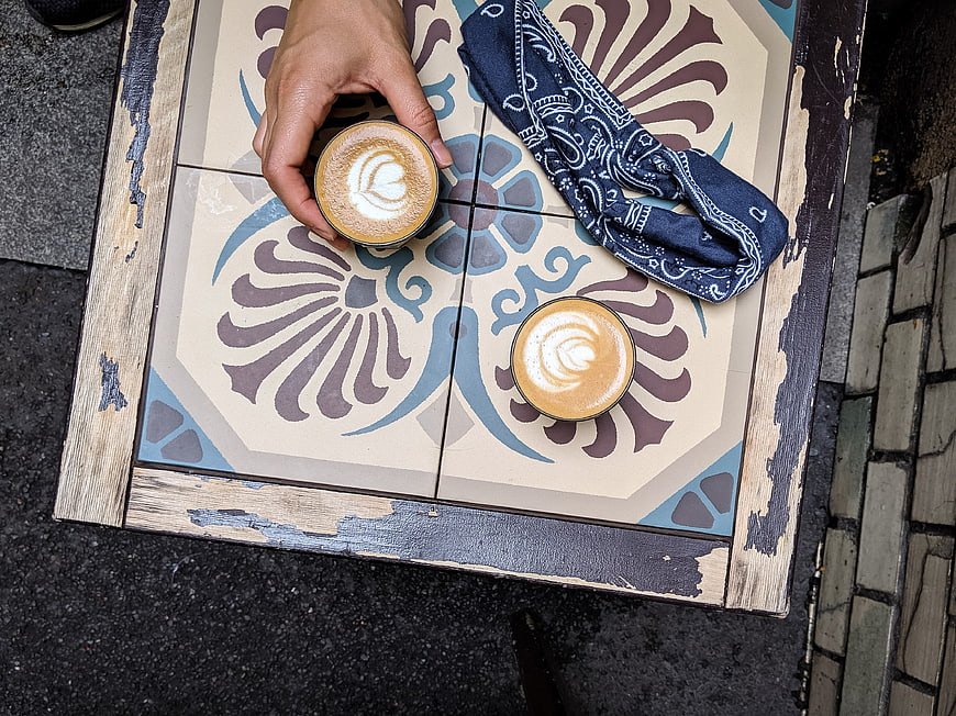Top View of Cappuccino Coffee on Patterned Table