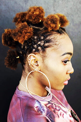 Profile of Woman with Braided Buns and Hoop Earrings