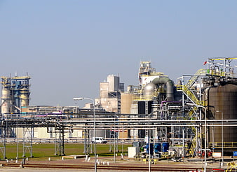 Wide shot of industrial chemical plant with pipes and tanks