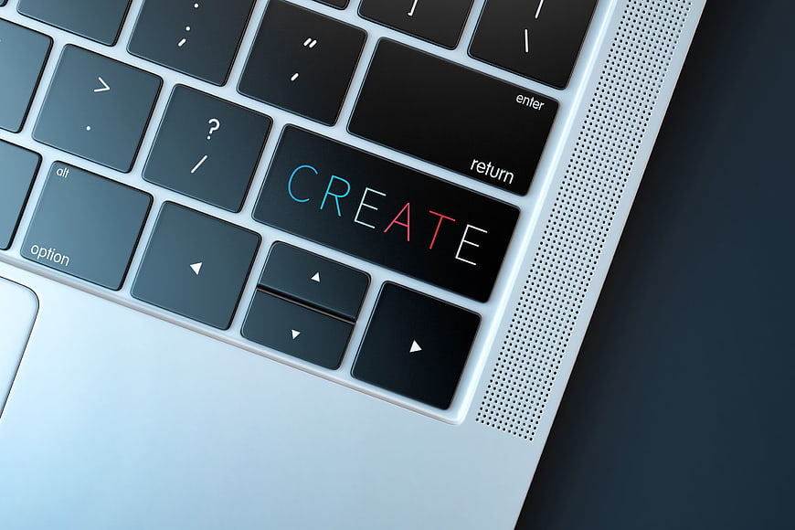 Close-up of laptop keyboard with CREATE text on key