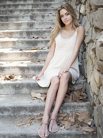 Young Woman in White Dress Sitting on Concrete Stairs