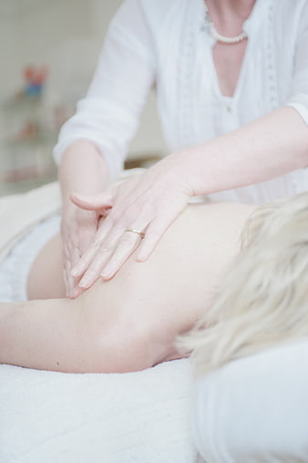Close-up of hands performing a relaxing back massage in a spa