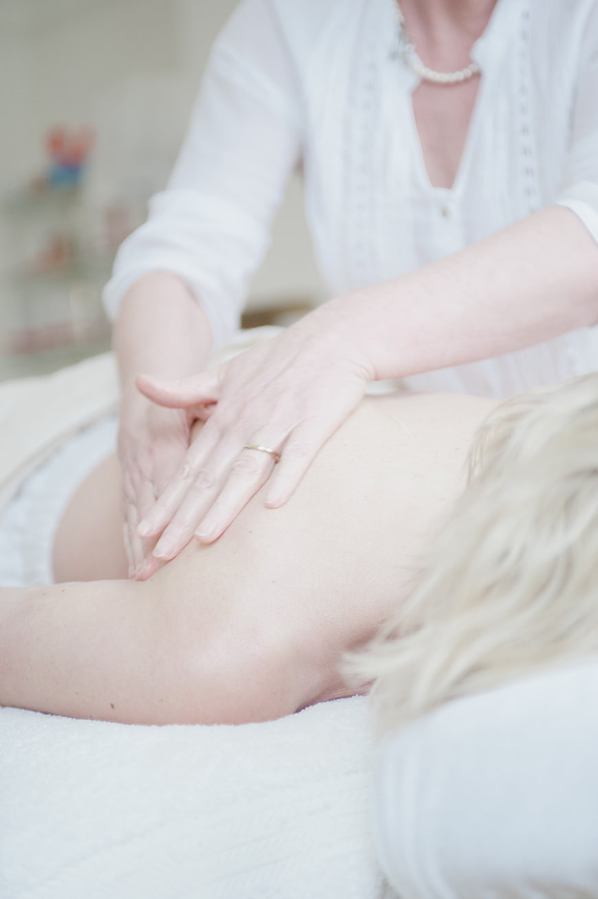 Close-up of hands performing a relaxing back massage in a spa