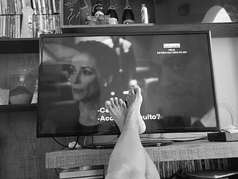 Relaxed Feet Propped Up While Watching Television In Living Room