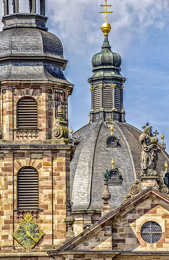 Historic Sandstone Church Facade With Golden Cross And Dome